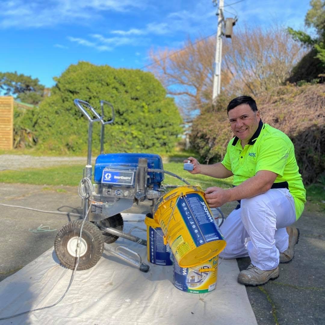 owner of Montado Painting holding paint brush and paint bucket